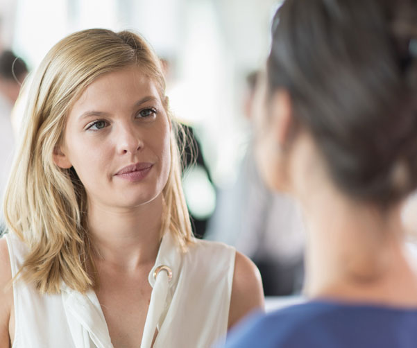 Two women discussing youth cancer services