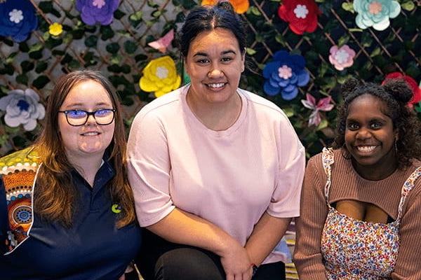 three young women smiling 