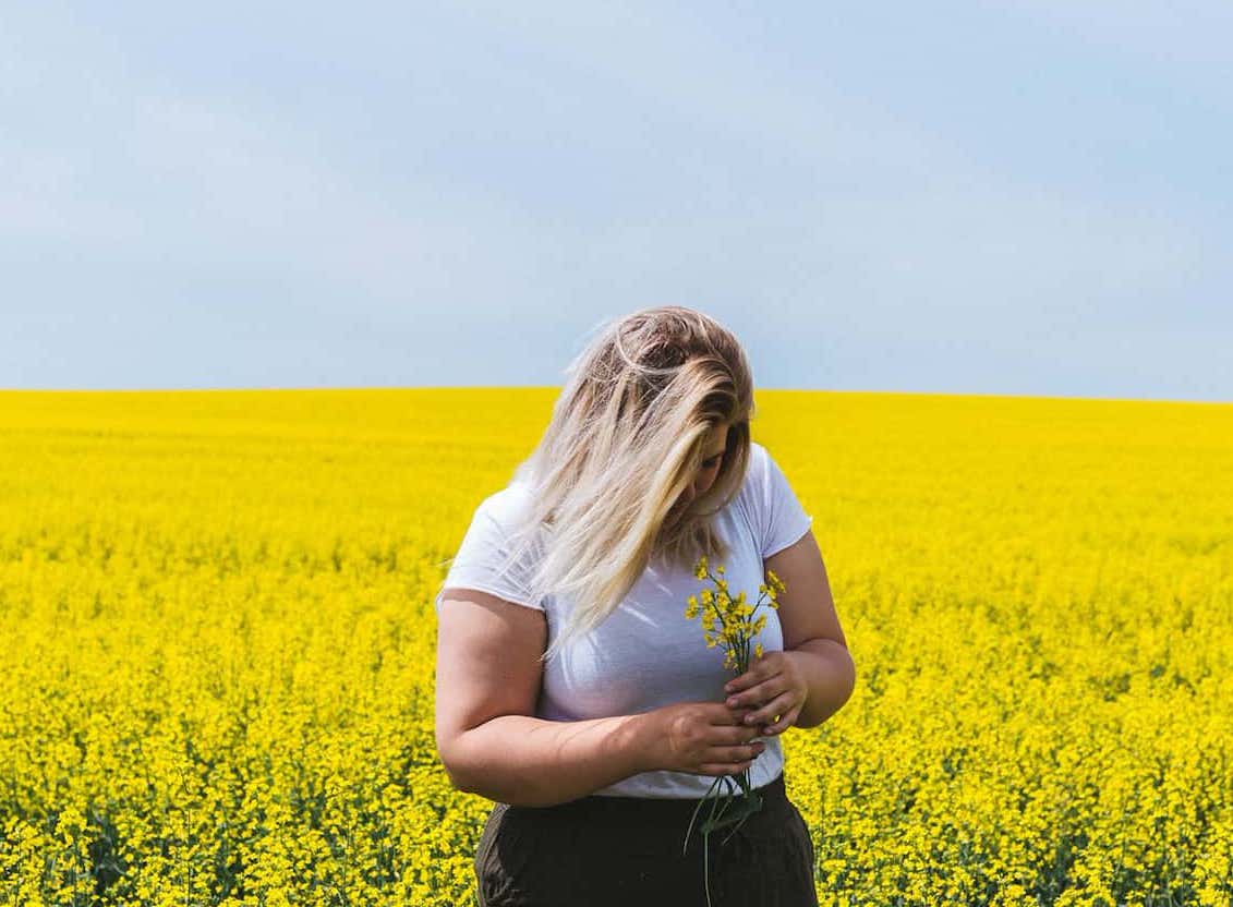 girl holding flowers in a field