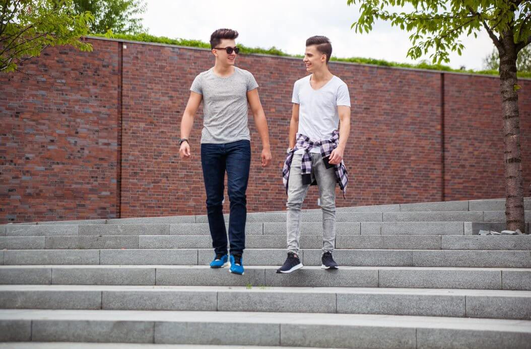 two friends walking together in urban area