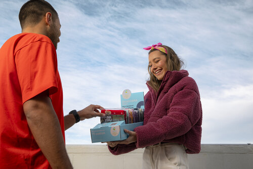 a person buying a bandanna from a bandanna box