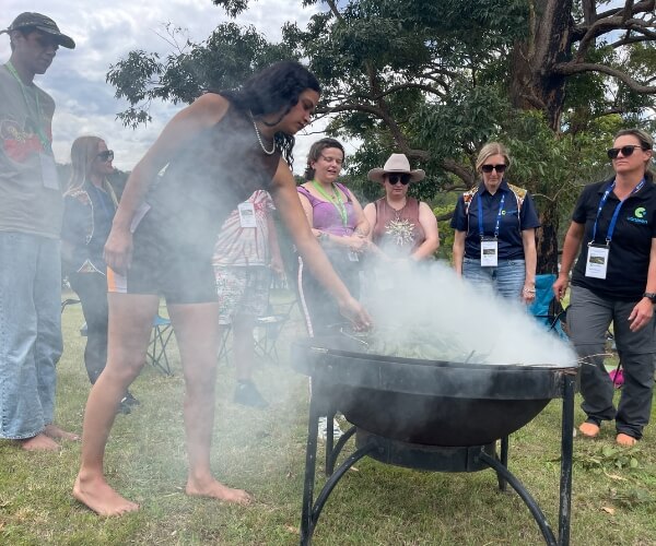 people standing around a fire at the hawkesbury canteen program