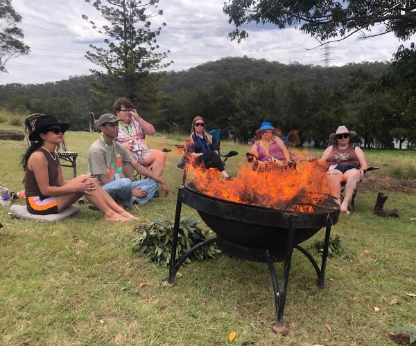  people sitting around a fire at the hawkesbury canteen program 