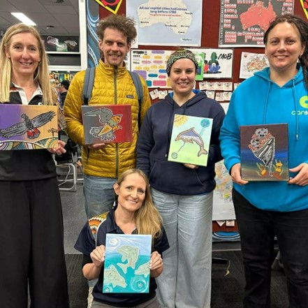 canteen staff holding indigenous art