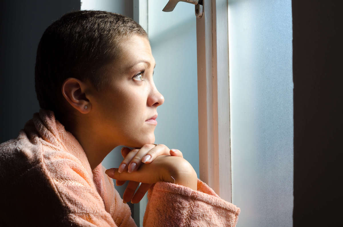 girl with no hair looking into distance