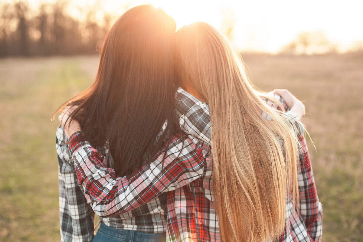 two friends arm in arm