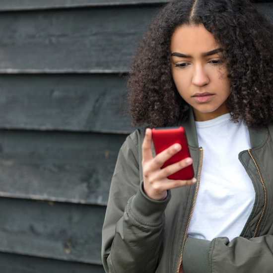 Girl looking for information about cancer on phone