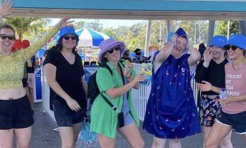 young people impacted by cancer having fun in front of the raging waters park entry