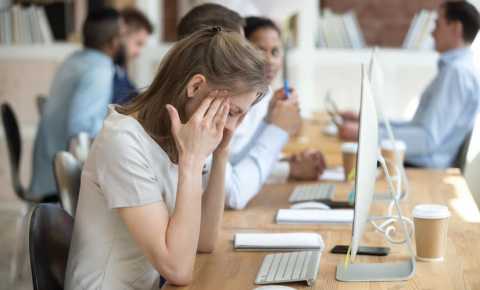 young woman trying to cope at work