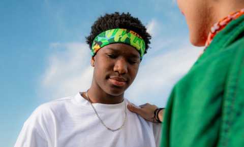 a young person getting consoled by a friend