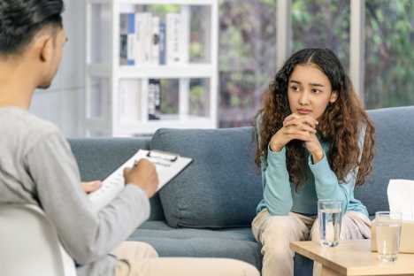 Young woman speaking to specialist