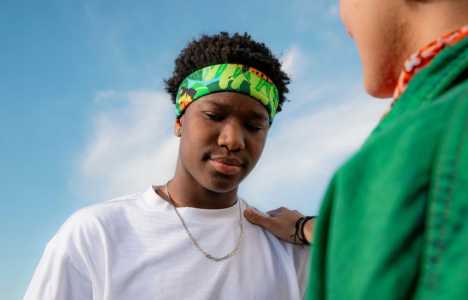 a young person getting consoled by a friend