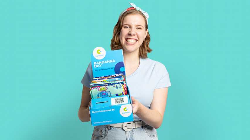 Young person holding a box of Canteen Bandannas
