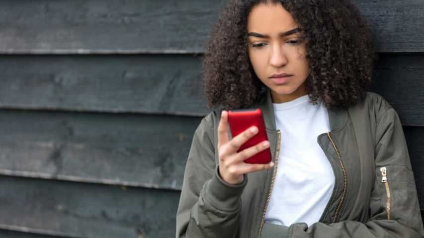 Girl looking for information about cancer on phone