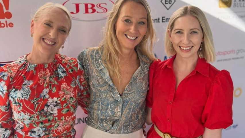 pillow talk team in front of a media wall