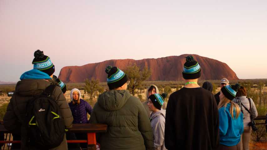 group of young people and staff from Canteen admiring Uluru
