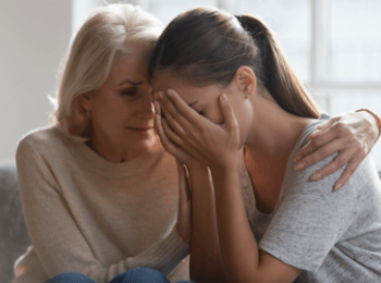 Mother comforting daughter