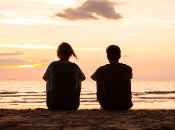 Siblings say goodbye on beach