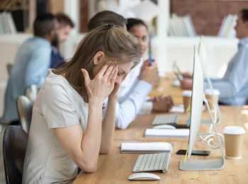 young woman trying to cope at work